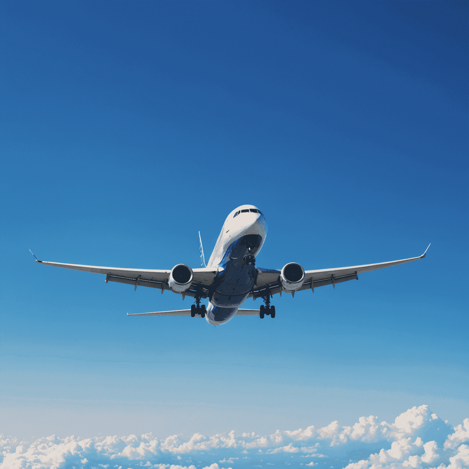 A modern airplane flying through a clear blue sky, symbolizing Gmqn's comprehensive airline network